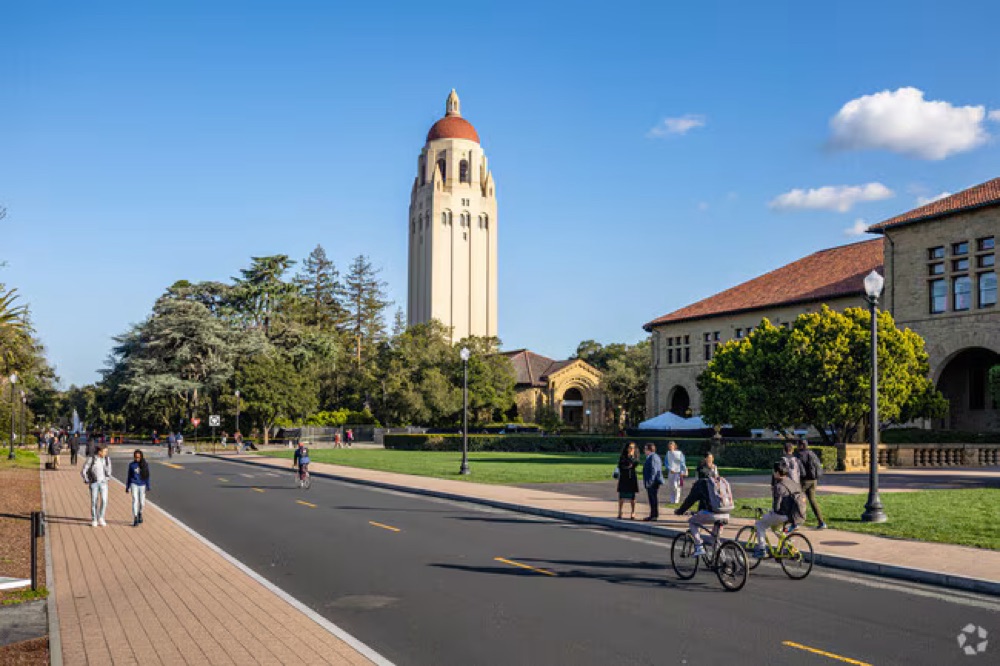 Hoover Tower and students biking