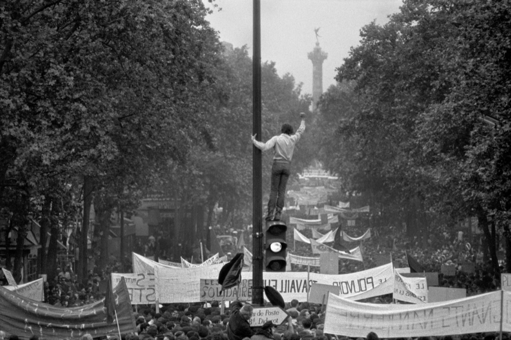A protester raising a fist above a march