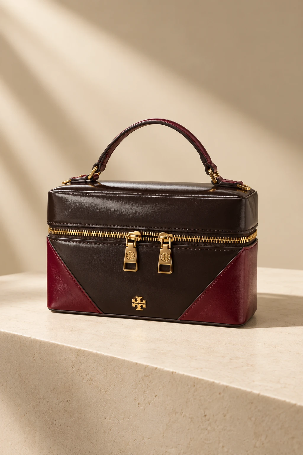 Lacquer: espresso leather vanity case with oxblood corner panels and gold hardware