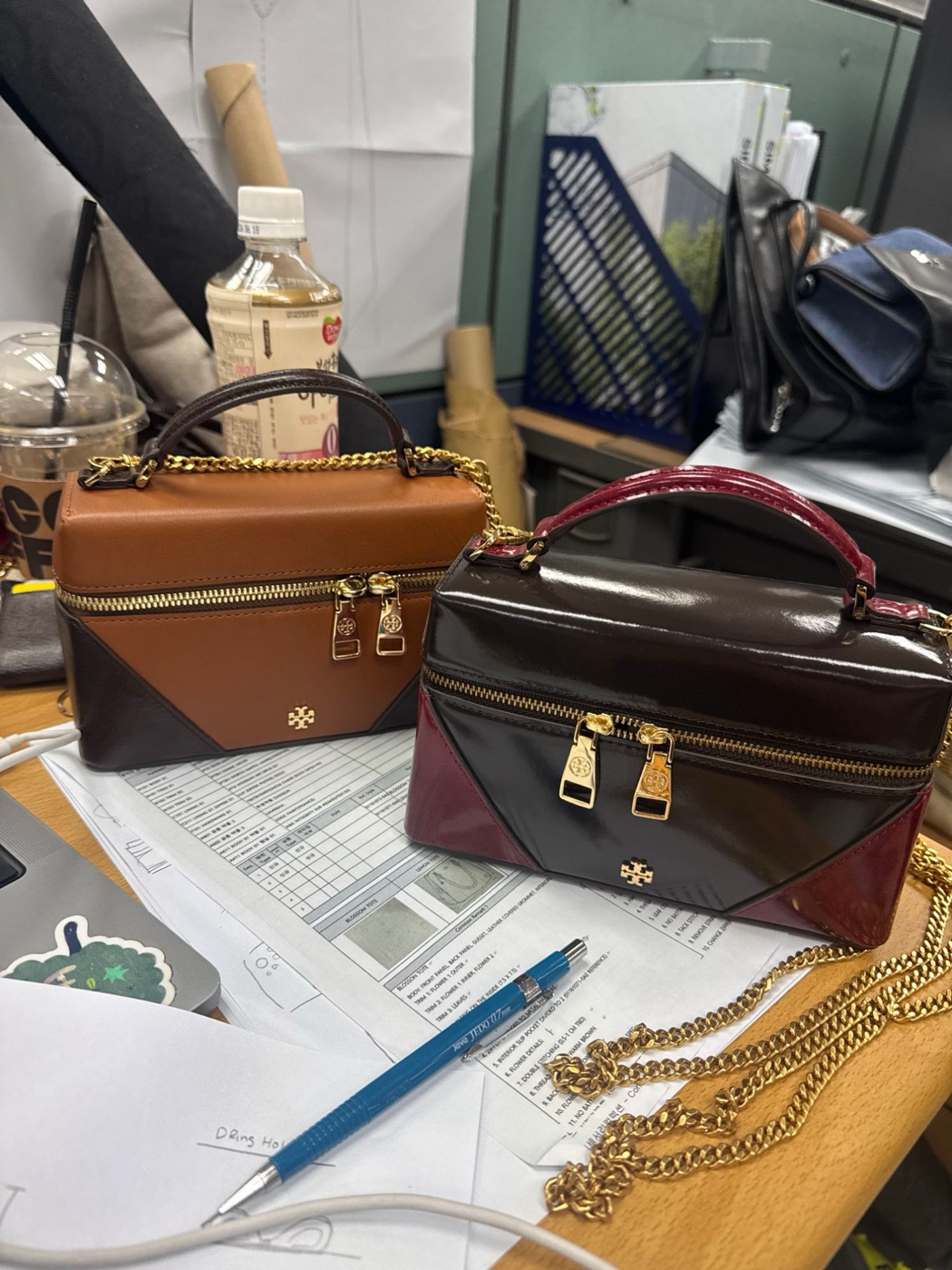 Both samples on a desk with tech sheets and the chain strap